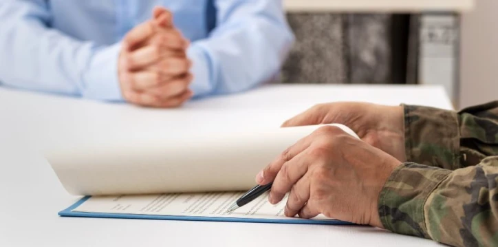 Military member signing divorce paperwork