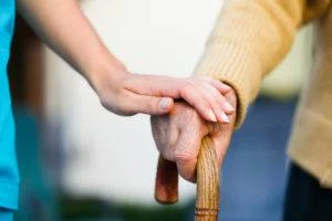 A nursing home nurse showing compassion to an elderly woman