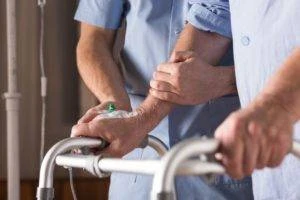 nurse walking with elderly patient