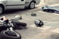 A motorcycle helmet lies next to the scene of an accident.