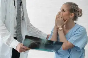 A female patient is upset as a doctor explains a mistake.