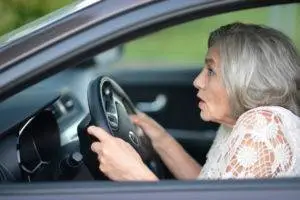 A senior woman driving her car.