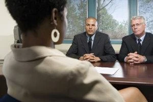 white businessmen talking to a black employee