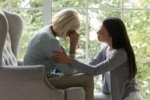 woman comforts an older woman