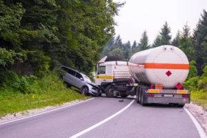 large commercial vehicle crashing into passenger car