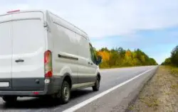 commercial van driving down roadway