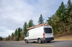 compact commercial vehicle traveling down road