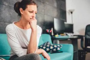 distraught woman sitting on couch