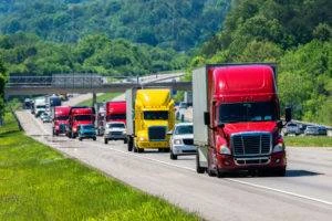 large commercial trucks driving down highway