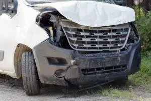 smashed-in front of delivery van after accident
