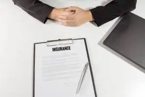 business person with insurance offer on clipboard.