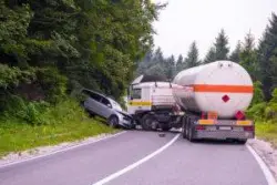 highway accident involving car and large fuel truck