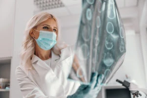 doctor examines patient’s brain scan