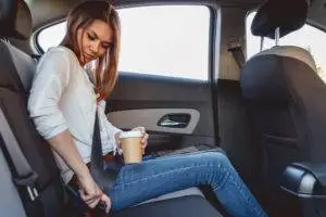 female-rideshare-passenger-buckles-into-backseat