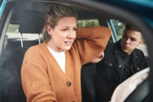 A passenger experiencing neck pain after a crash.