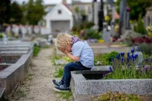 child crying in graveyard