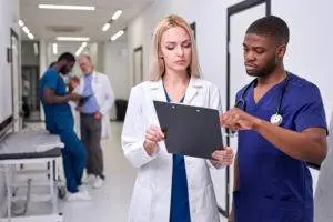 doctor and nurse discuss medical charts