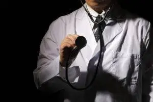 doctor in shadow holding stethoscope
