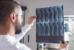 patient looks at x-ray of spine