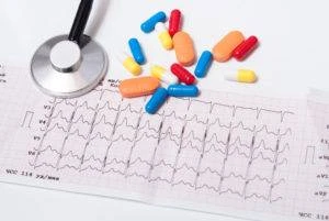 pills and an ecg readout on table