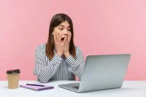shocked woman looking at work laptop