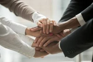 team members join hands