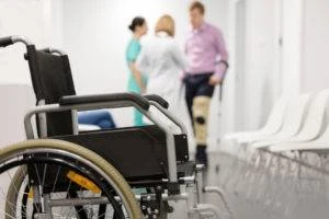 wheelchair sits while patient discusses medical care