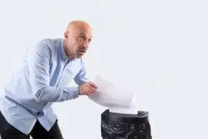 worried man destroying documents