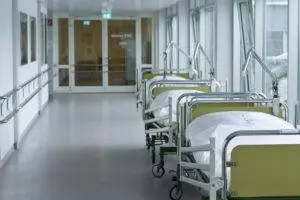 beds lined up in hospital corridor
