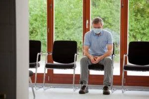 pensive hospital visitor sitting alone