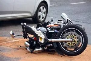 a damaged motorcycle and car after a crash