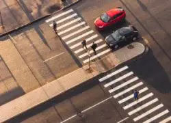 aerial view pedestrians walking across crosswalk