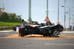 an overturned motorcycle in the middle of the road