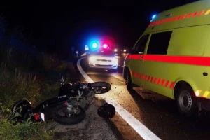 an overturned motorcycle on the side of the road