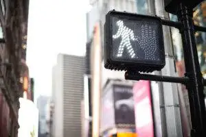 crosswalk sign lit up to signal that walking is permitted