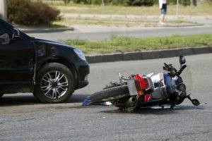 damaged car and motorcycle after collision