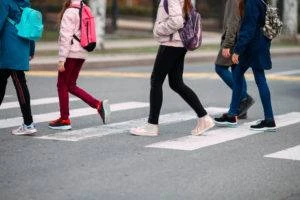 four pedestrians cross street