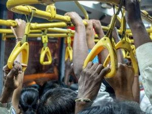 standing room only on bus showing passengers hands