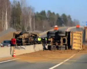 dump-truck-overturned-on-highway-barrier-accident
