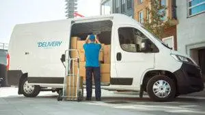 man-loads-packages-into-delivery-truck