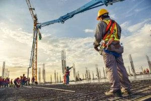 construction-worker-observes-crane-operation-work-site