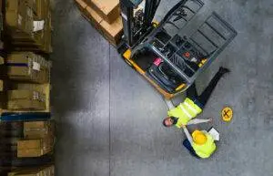 injured-man-lying-by-a-forklift