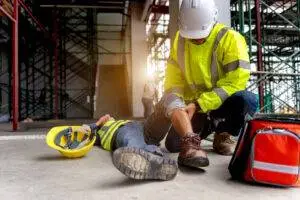 A Construction Worker At A Worksite Receiving Treatment For An Injury