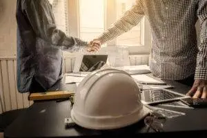 construction-worker-and-lawyer-shake-hands-hardhat