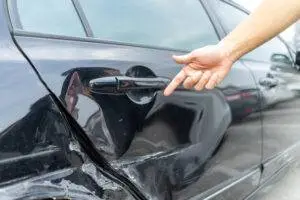 driver-pointing-at-hit-and-run-vehicle-damage
