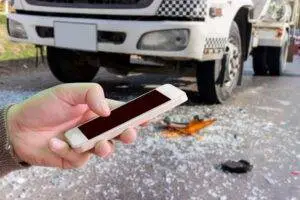 man-use-mobile-phone-blur-image-of-car-accident-as-background