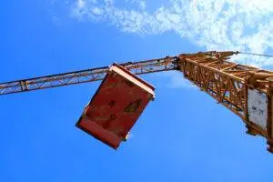 A crane carrying a heavy load in the sky. Would you know which St. Charles crane accident lawyer to call if this load slipped?