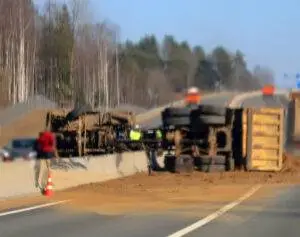 This dump truck broke through a highway meridian and turned over. A Mount Vernon construction truck accident lawyer could help you if you get hurt in such a situation.