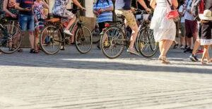 Pedestrians and bicyclists cross a busy walkway.