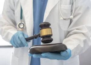 A doctor holds a gavel.